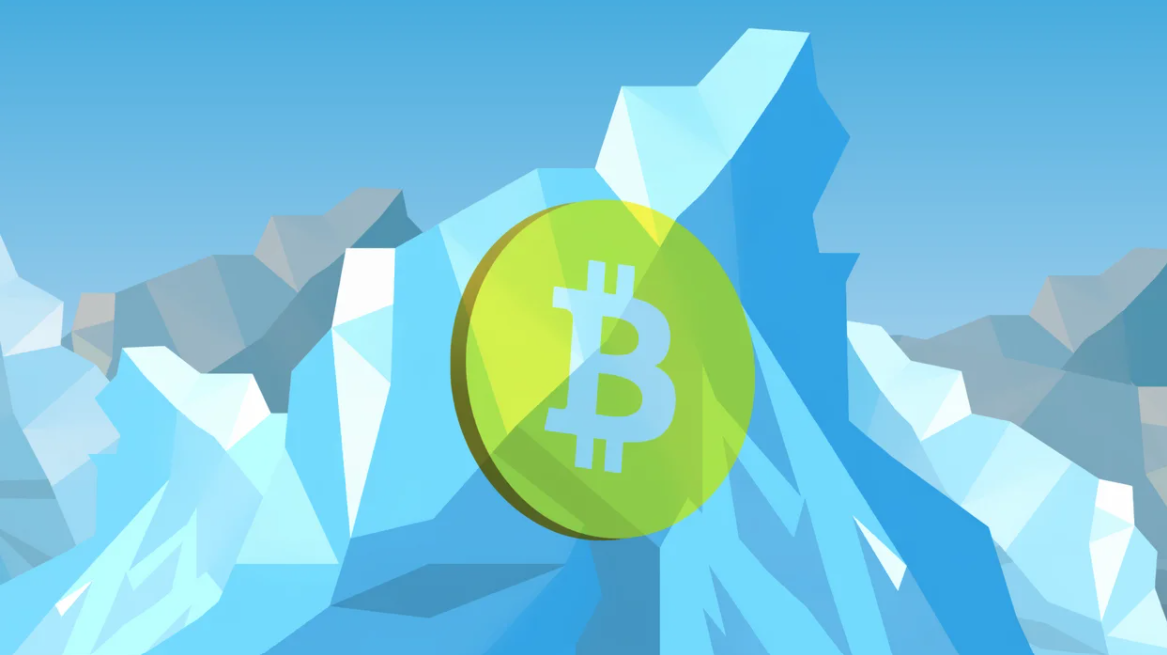 A bitcoin sits inside an iceberg