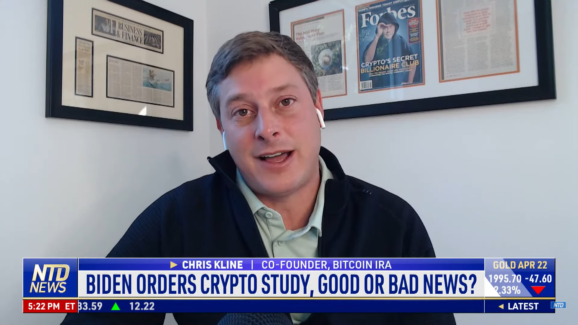 Chris Kline sits in his office with a news headline about Biden crypto study below him