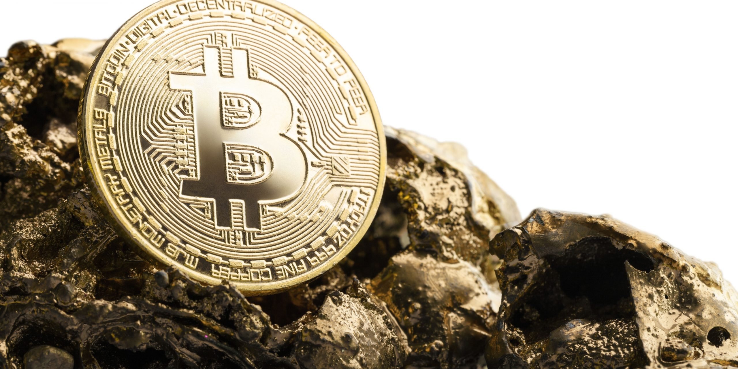 Bitcoin displayed over a piece of gold rock
